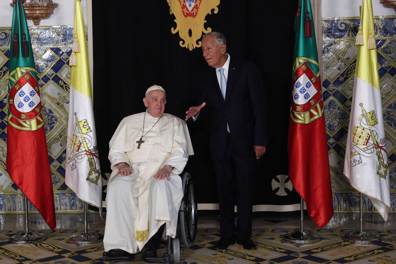Pope Francis and Portuguese President Marcelo Rebelo de Sousa (R) review the troops at the National Palace in Belem, Lisbon, during his five-day visit to attend the World Youth Day (WYD) gathering of young Catholics, on August 2, 2023. Pope Francis arrived in Lisbon today to gather with a million youngsters from across the world at the World Youth Day (WYD), held as the Church reflects on its future. The 86-year-old underwent major abdominal surgery just two months ago, but that has not stopped an event-packed 42nd trip abroad, with 11 speeches and around 20 meetings scheduled. (Photo by Thomas COEX / AFP)