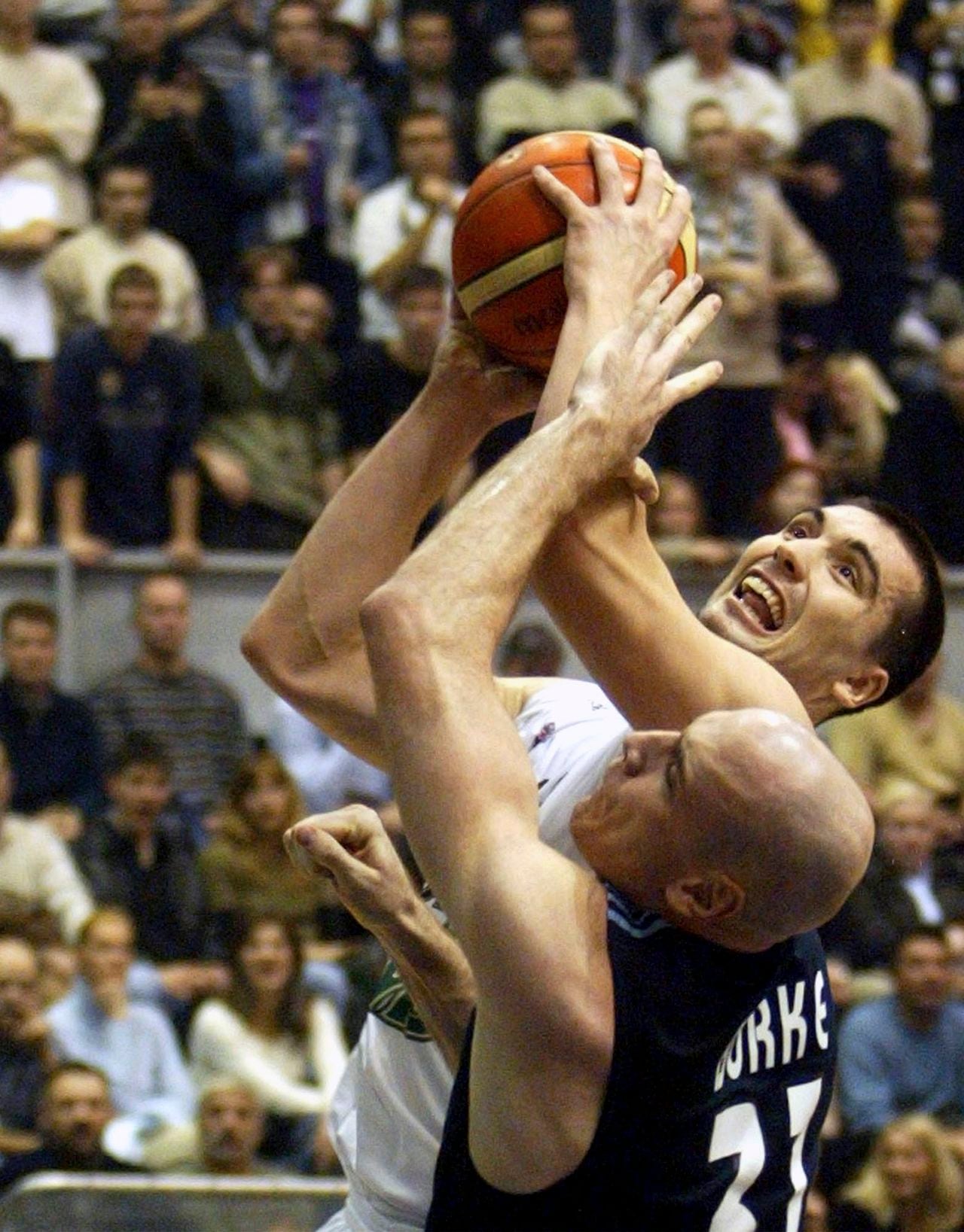 File - Real Madris's Patrick Burke, front, challenges Dejan Milojevic, of Partizan Pivara MB, for the ball during their Euroleague, group A, third round basketball match in Belgrade, Thursday, Nov. 18, 2004.