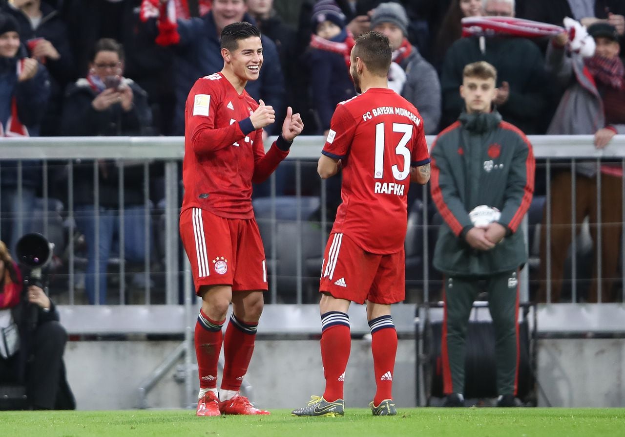 MUNICH, GERMANY - MARCH 09: James Rodriguez of Bayern Munich celebrates with teammate Rafinha after scoring his team's third goal during the Bundesliga match between FC Bayern Muenchen and VfL Wolfsburg at Allianz Arena on March 09, 2019 in Munich, Germany. (Photo by Alex Grimm/Bongarts/Getty Images)