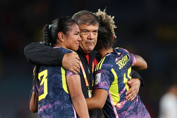 SYDNEY, AUSTRALIA - AUGUST 12: Daniela Arias and Jorelyn Carabali of Colombia are consoled by Nelson Abadia, Head Coach of Colombia, after the team's defeat in the FIFA Women's World Cup Australia & New Zealand 2023 Quarter Final match between England and Colombia at Stadium Australia on August 12, 2023 in Sydney, Australia. (Photo by Catherine Ivill/Getty Images )