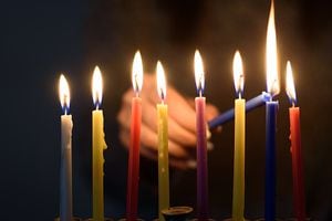A person lighting Hanukkah Candles in a menorah. People celebrate Chanukah by lighting candles on a menorah, also called a Hanukiyah. Each night, one more candle is lit.