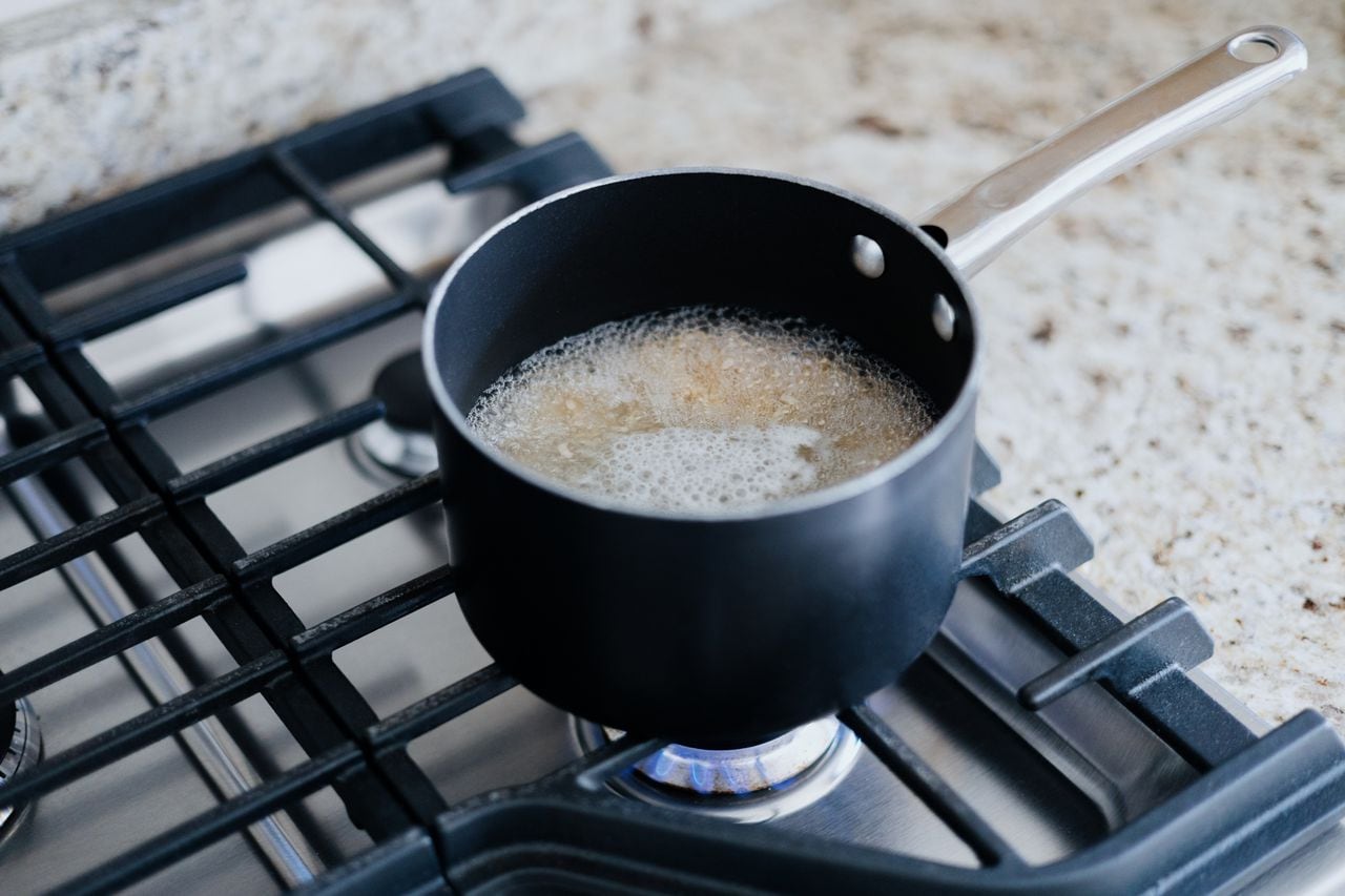 Close-up of food boiling in pot on gas cooktop