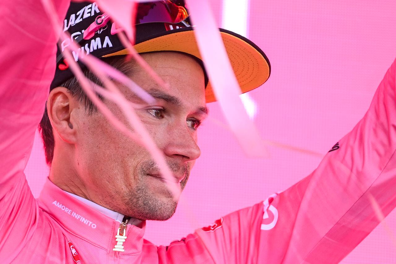 Slovenia's Primoz Roglic wears the pink jersey of the overall leader as he celebrates on the podium at the end of the 20th stage of the Giro d'Italia cycling race, an individual mountain time trial from Tarvisio to Monte Lussari, Italy, Saturday, May 27, 2023. Roglic all but secured the Giro d’Italia title on Saturday by overtaking leader Geraint Thomas on the penultimate stage despite having a mechanical problem on the mountain time trial. (Fabio Ferrari/LaPresse via AP)