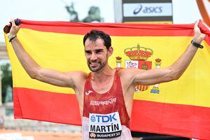 El ganador de la carrera, el español Álvaro Martín, celebra con una bandera española después de la final masculina de 20 km de caminata durante el Campeonato Mundial de Atletismo en Budapest el 19 de agosto de 2023. (Foto de Attila KISBENEDEK / AFP)