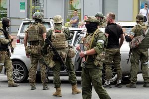 Members of Wagner group inspect a car in a street of Rostov-on-Don, on June 24, 2023. President Vladimir Putin on June 24, 2023 said an armed mutiny by Wagner mercenaries was a "stab in the back" and that the group's chief Yevgeny Prigozhin had betrayed Russia, as he vowed to punish the dissidents. Prigozhin said his fighters control key military sites in the southern city of Rostov-on-Don. (Photo by STRINGER / AFP)