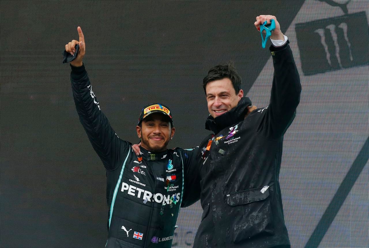FILE  - Mercedes driver Lewis Hamilton of Britain and Mercedes team principal Toto Wolff, right, celebrate after Hamilton won the race and his seventh world championship at the Formula One Turkish Grand Prix at the Istanbul Park circuit racetrack in Istanbul, Sunday, Nov. 15, 2020.  Lewis Hamilton’s decision to leave Mercedes for Ferrari shocked the Formula One world with even Mercedes team principal Toto Wolff calling it a