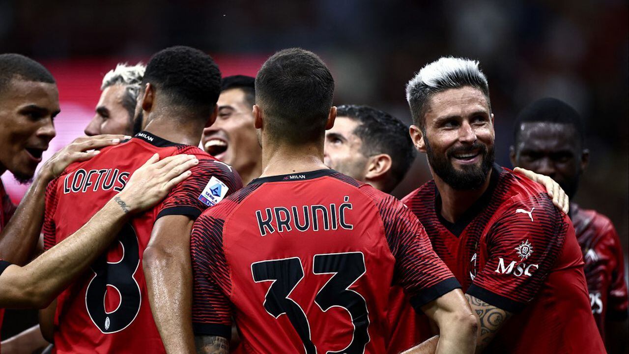 AC Milan's French forward Olivier Giroud (R) celebrates with teammates after scoring during the Italian Serie A football match AC Milan vs Torino on August 26, 2023 at the �San Siro Stadium� in Milan. (Photo by MARCO BERTORELLO / AFP)