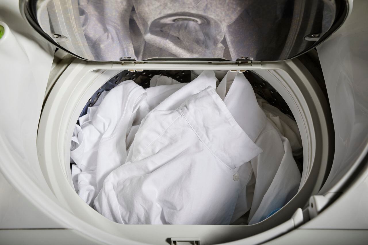 A lot of white clothing in the washing machine.