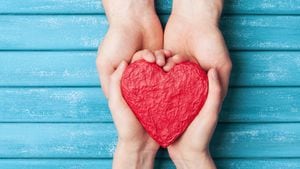Manos de mujer y hombre con forma roja de corazón. Fondo del día de san valentín. Concepto de relación, familia y donación.