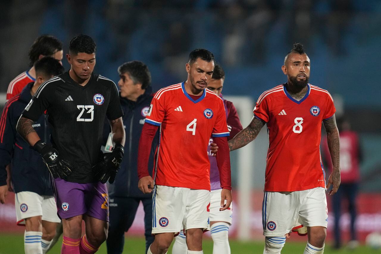 Chile's goalkeeper Brayan Cortes, left, Gabriel Suazo, center, and Arturo Vidal leave the field at the end of a qualifying soccer match against Uruguay for the FIFA World Cup 2026 at Centenario stadium in Montevideo, Uruguay, Friday Sept. 8, 2023.(AP Photo/Matilde Campodonico)