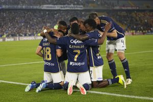 Daniel Ruiz of Colombia's Millonarios, left, celebrates with teammates after scoring his side's opening goal against Brazil's Flamengo during a Copa Libertadores Group E soccer match at El Campin stadium in Bogota, Colombia, Tuesday, April 2, 2024. (AP Photo/Fernando Vergara)