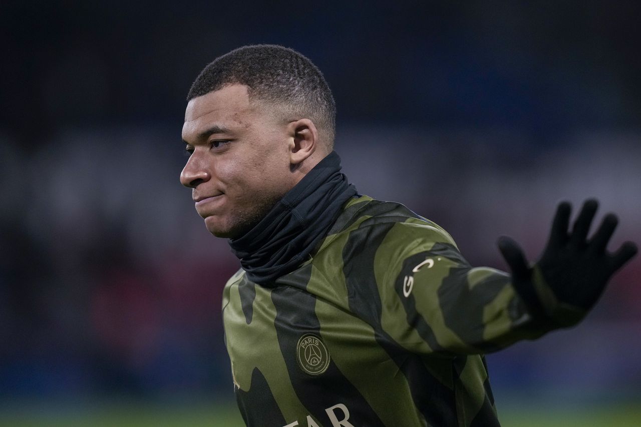 PSG's Kylian Mbappe waves as he warms up prior to the French League One soccer match between Paris Saint-Germain and Brest at the Parc des Princes stadium in Paris, France, Sunday, Jan. 28, 2024. (AP Photo/Thibault Camus)