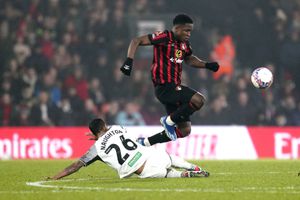 Bournemouth's David Brooks, right, jumps over the tackle of Swansea City's Kyle Naughton during the English FA Cup Fourth Round soccer match between AFC Bournemouth and Swansea City at the Vitality Stadium, Bournemouth, England, Thursday, Jan. 25, 2024. (Andrew Matthews/PA via AP)