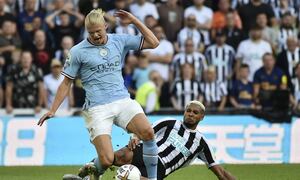 Newcastle's Joelinton, right, challenges Manchester City's Erling Haaland during the English Premier League soccer match between Newcastle United and Manchester City at St James Park in Newcastle, England, Sunday, Aug.21, 2022. (AP Photo/Rui Vieira)