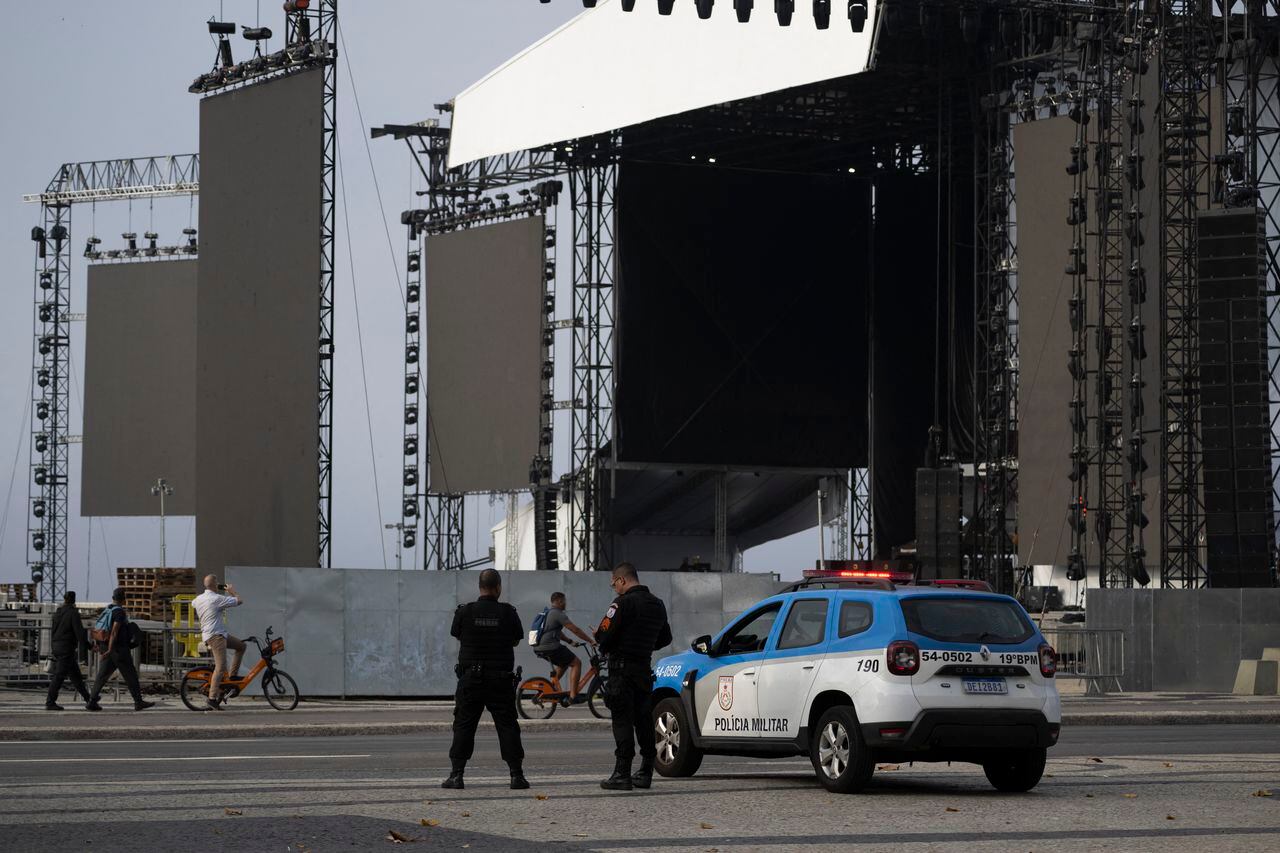 Police officers stand guard close to the stage for the show of US pop star Madonna is being set in Rio de Janeiro, Brazil, on April 29, 2024. Madonna will perform a free mega-concert on May 4 on Rio de Janeiro's Copacabana beach to close her 'Celebration' tour. (Photo by Pablo PORCIUNCULA / AFP)
