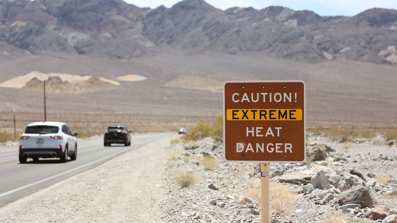 A heat advisory sign is shown along US highway 190 during a heat wave in Death Valley National Park in Death Valley, California, on July 16, 2023. Tens of millions of Americans braced for more sweltering temperatures Sunday as brutal conditions threatened to break records due to a relentless heat dome that has baked parts of the country all week. By the afternoon of July 15, 2023, California's famous Death Valley, one of the hottest places on Earth, had reached a sizzling 124F (51C), with Sunday's peak predicted to soar as high as 129F (54C). Even overnight lows there could exceed 100F (38C). (Photo by Ronda Churchill / AFP)