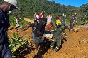 Handout picture released by the Colombian Police press office showing members of the rescue teams carrying a corpse from the area of a landslide in the road between Quibdo and Medellin, Choco Department, Colombia, on January 12, 2024. At least 23 people were killed and around 20 are injured after a landslide in an indigenous community in northwestern Colombia, an official from the Choco department governor's office told AFP. (Photo by Handout / Colombian Police / AFP) / RESTRICTED TO EDITORIAL USE - MANDATORY CREDIT "AFP PHOTO / COLOMBIAN POLICE" - NO MARKETING - NO ADVERTISING CAMPAIGNS - DISTRIBUTED AS A SERVICE TO CLIENTS