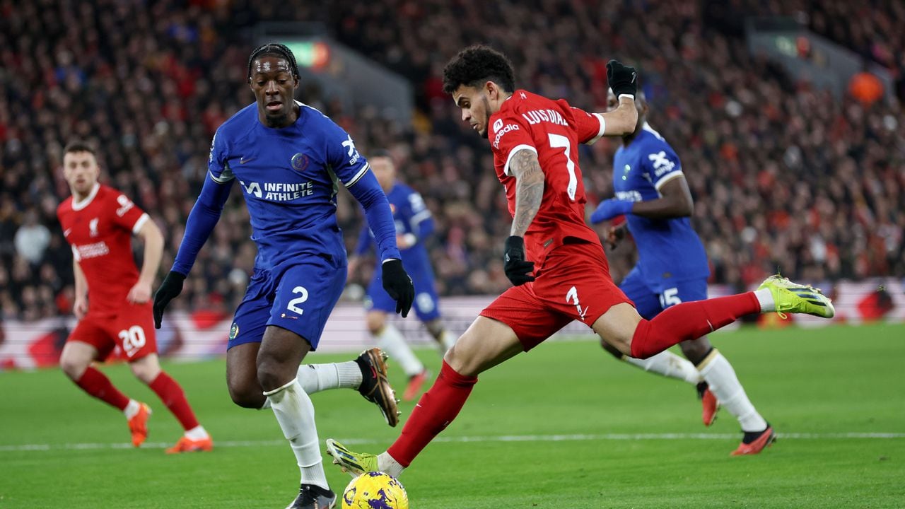 LIVERPOOL, ENGLAND - JANUARY 31: Luis Diaz of Liverpool shoots whilst under pressure from Axel Disasi of Chelsea during the Premier League match between Liverpool FC and Chelsea FC at Anfield on January 31, 2024 in Liverpool, England. (Photo by Clive Brunskill/Getty Images)