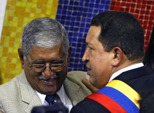 Venezuelan President Hugo Chavez (R) talks to his father Hugo de los Reyes Chavez (L), at the National Assembly in Caracas, 15 August 2007, during his presentation of a project to modify the Constitution. Chavez prepared to offer Wednesday changes to Venezuela's Constitution to allow the head of state to run for office multiple times and tighten executive control over local government. Chavez wants to modify the Constitution, which was already rewritten under him in 1999, to cement his vision of the "21st Century Socialism" and lift term limits that allow the President to serve only two consecutive six-year terms. AFP   PHOTO/Juan BARRETO (Photo by JUAN BARRETO / AFP)