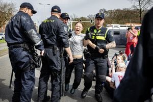 Swedish climate activist Greta Thunberg (C) is arrested during a climate march against fossil subsidies near the highway A12 in the Hague, on April 6, 2024. Dozens of police officers, some on horseback, blocked protesters from reaching the A12 arterial highway into the Dutch seaside city, the scene of previous actions organised by the Extinction Rebellion (XR) group (Photo by Ramon van Flymen / ANP / AFP) / Netherlands OUT