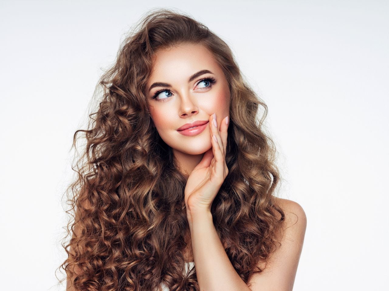 Young woman with brown voluminous and curly hair