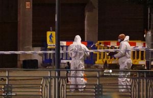 Belgian police officers from the forensic service search for evidence in a street after two people were killed during a shooting in Brussels on October 16, 2023 evening by a suspect who is on the run, the Belgian capital's prosecutor's office said. The alleged gunman in a fluorescent orange jacket fled the scene after using an automatic rifle, according to a video shared by Flemish newspaper Het Laatste Nieuws. A spokeswoman for the prosecutor's office said an investigation had been opened but did not speculate on the gunman's motive. (Photo by Kenzo TRIBOUILLARD / AFP)