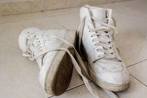 White dirty sneakers on the floor