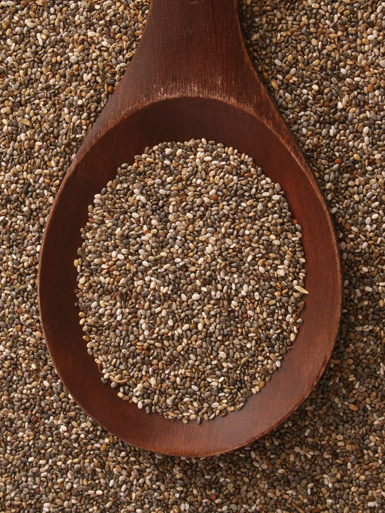 Top view of wooden spoon with chia seeds on it