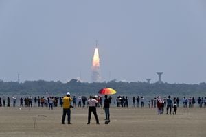 People watch as the PSLV XL rocket carrying the Aditya-L1 spacecraft, the first space-based Indian observatory to study the Sun, is launched from the Satish Dhawan Space Centre in Sriharikota on September 02, 2023. The latest mission in India's ambitious space programme blasted off September 2, on a voyage to the centre of the solar system, a week after the country's successful unmanned Moon landing. Aditya-L1 is carrying scientific instruments to observe the Sun's outermost layers, launching shortly before midday to begin its four-month journey. (Photo by R. Satish BABU / AFP)