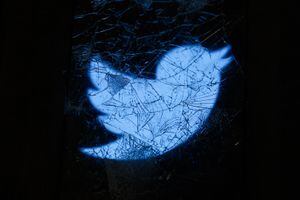 Twitter logo displayed on a phone screen is seen through the broken glass in this illustration photo taken in Krakow, Poland on November 5, 2022. (Photo by Jakub Porzycki/NurPhoto via Getty Images)