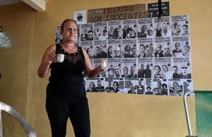 Liset Fonseca, mother of Roberto Perez Fonseca, detained in the July 11th protests against the government, stands near a poster of Cubans detained in the protests and their mothers, in San Jose de las Lajas, Mayabeque Province, Cuba, on June 22, 2023. Two years ago, Marta Perdomo and Liset Fonseca, two Cuban mothers, were not interested in politics or social networks. But the fate of their children, condemned for their participation in the demonstrations of July 11, 2021, made them tireless activists fighting for their release. (Photo by YAMIL LAGE / AFP)