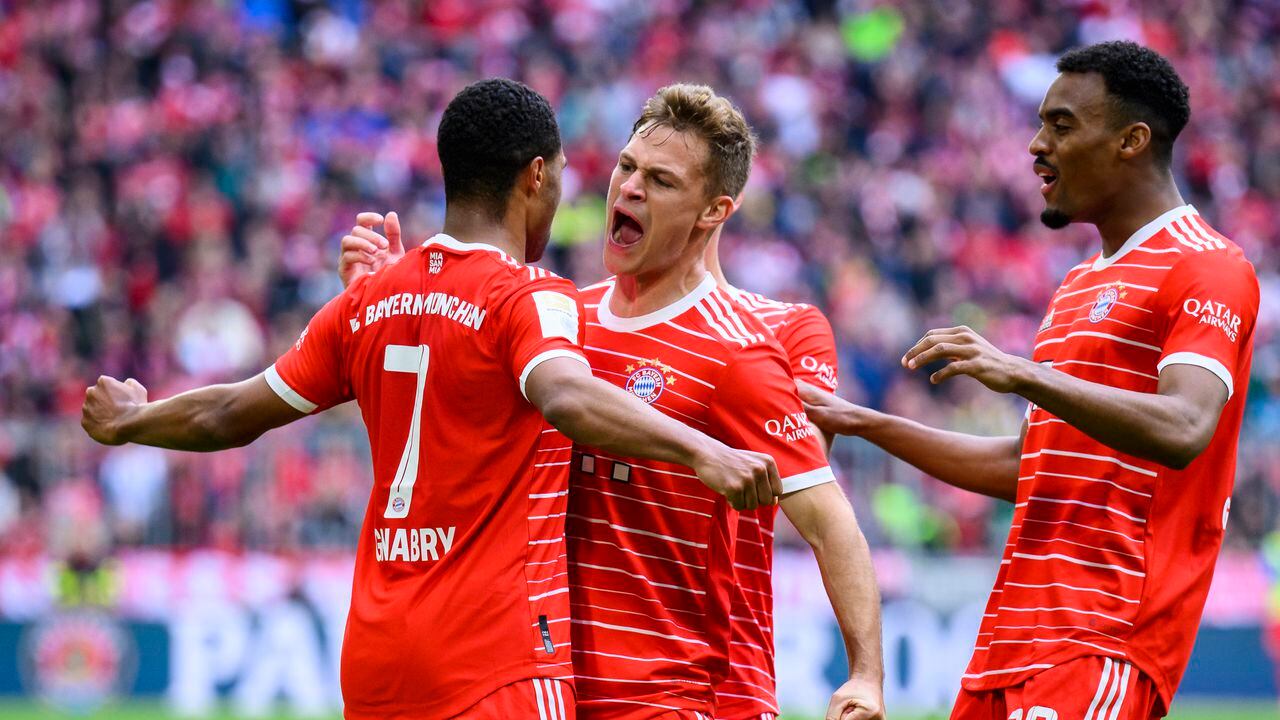 Munich's scorer Serge Gnabry, left, celebrates with his teammates Joshua Kimmich, center, and Ryan Gravenberch, right, celebrate their side's fourth goal during the German Bundesliga soccer match between FC Bayern Munich and FC Schalke 04 in Munich, Germany, Saturday, May 13, 2023. (Tom Weller/dpa via AP)