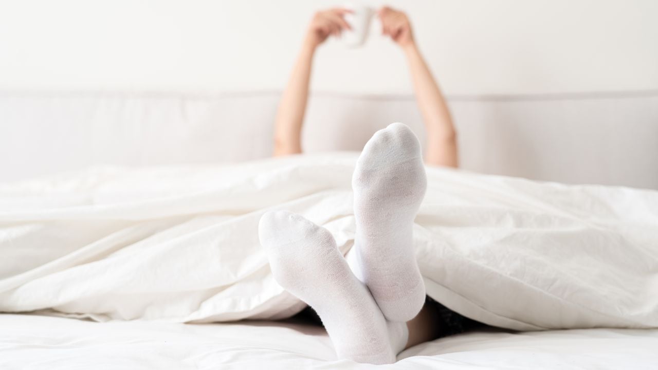 Mantener los pies calientes con medias puede prevenir la incomodidad causada por el frío durante la noche.