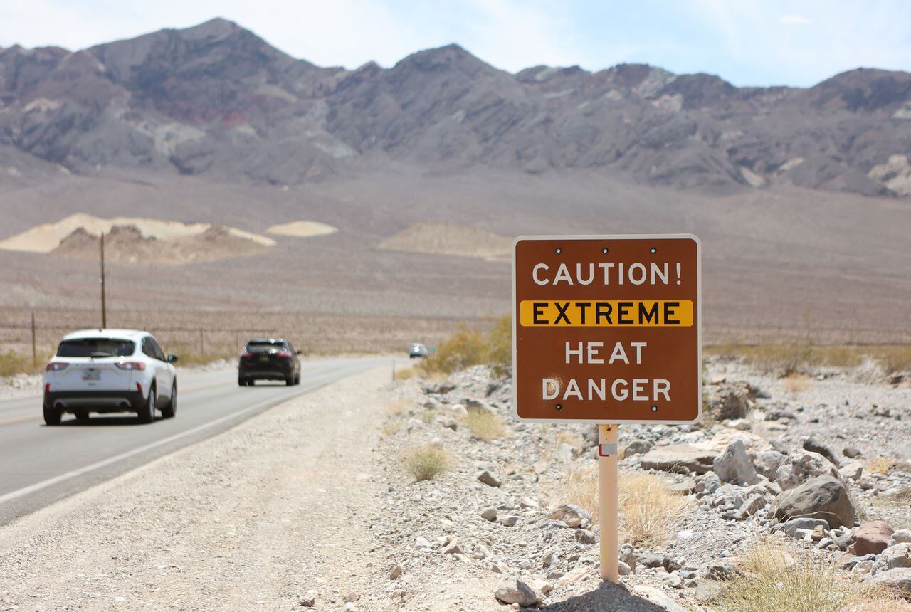 A heat advisory sign is shown along US highway 190 during a heat wave in Death Valley National Park in Death Valley, California, on July 16, 2023. Tens of millions of Americans braced for more sweltering temperatures Sunday as brutal conditions threatened to break records due to a relentless heat dome that has baked parts of the country all week. By the afternoon of July 15, 2023, California's famous Death Valley, one of the hottest places on Earth, had reached a sizzling 124F (51C), with Sunday's peak predicted to soar as high as 129F (54C). Even overnight lows there could exceed 100F (38C). (Photo by Ronda Churchill / AFP)
