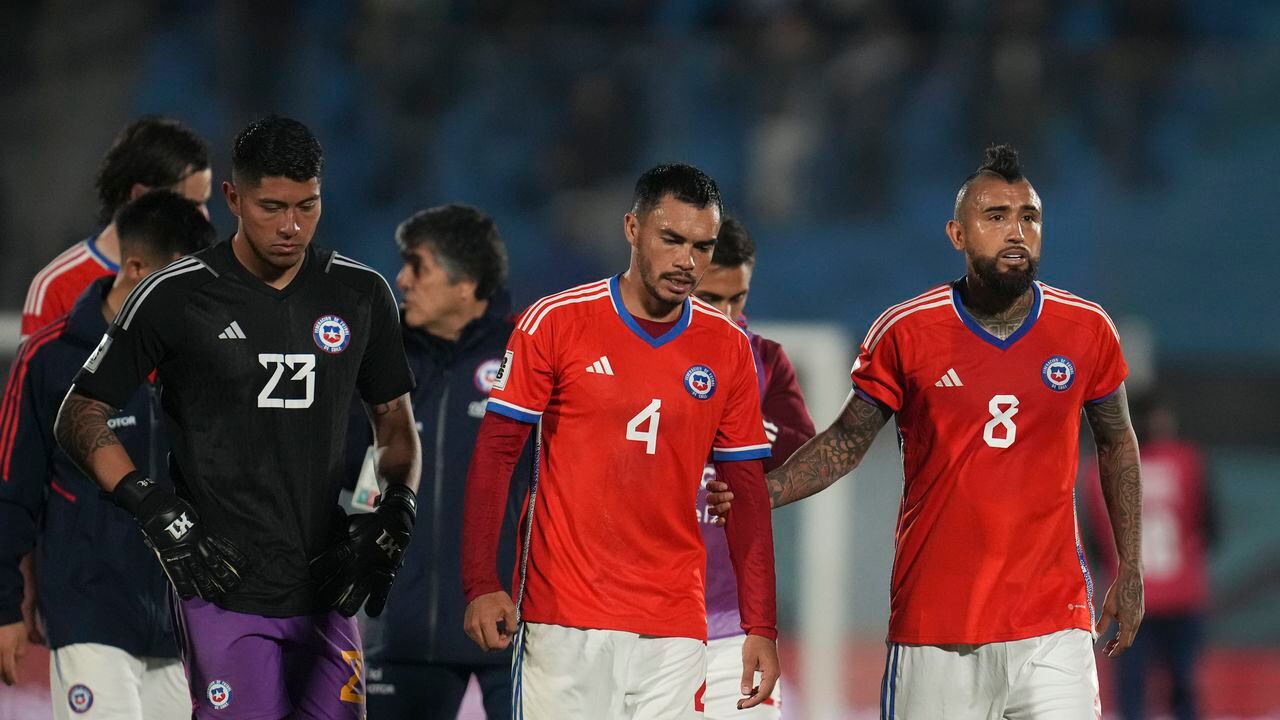 Chile's goalkeeper Brayan Cortes, left, Gabriel Suazo, center, and Arturo Vidal leave the field at the end of a qualifying soccer match against Uruguay for the FIFA World Cup 2026 at Centenario stadium in Montevideo, Uruguay, Friday Sept. 8, 2023.(AP Photo/Matilde Campodonico)