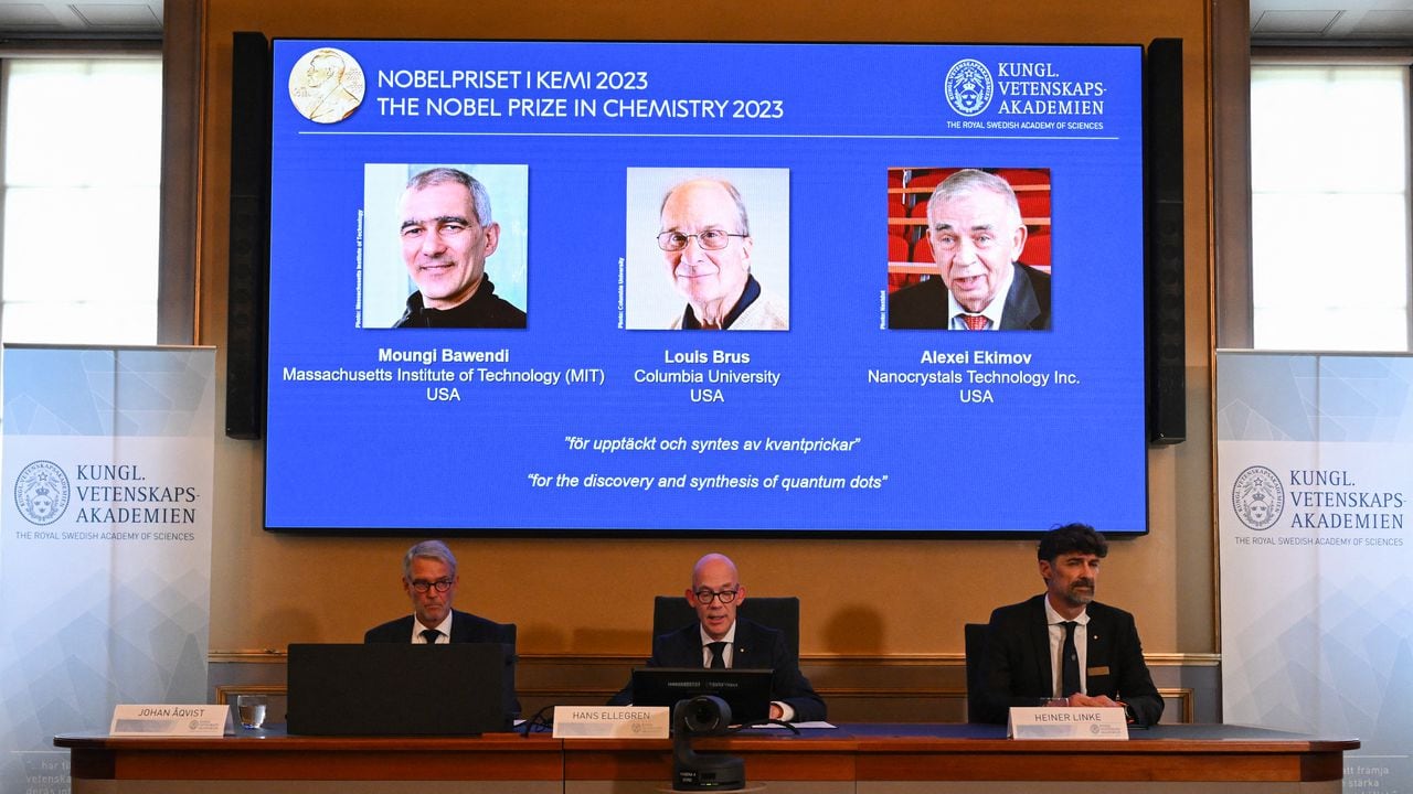 A screen shows this year's laureates US Chemist Moungi Bawendi, US Chemist Louis Brus and Russian physicist Alexei Ekimov during the announcement of the winners of the 2023 Nobel Prize in chemistry at Royal Swedish Academy of Sciences in Stockholm on October 4, 2023. French-born Moungi Bawendi, Louis Brus of the United States and Russian-born Alexei Ekimov  won the Nobel Chemistry Prize for research in semiconductor nanocrystals known as quantum dots. (Photo by Jonathan NACKSTRAND / AFP)