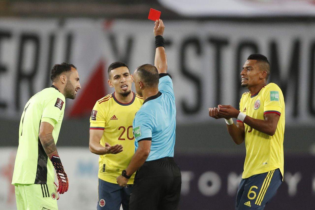 Referee Wilton Sampaio of Brazil sends off Colombia's Daniel Munoz during a qualifying soccer match for the FIFA World Cup Qatar 2022 against Peru at the National stadium in Lima, Peru, Thursday, June 3, 2021. (Paolo Aguilar/Pool via AP)