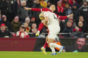 Liverpool's Wataru Endo, top, and Manchester United's Sofyan Amrabat challenge for the ball during the English Premier League soccer match between Liverpool and Manchester United at the Anfield stadium in Liverpool, England, Sunday, Dec.17, 2023. (AP Photo/Jon Super)