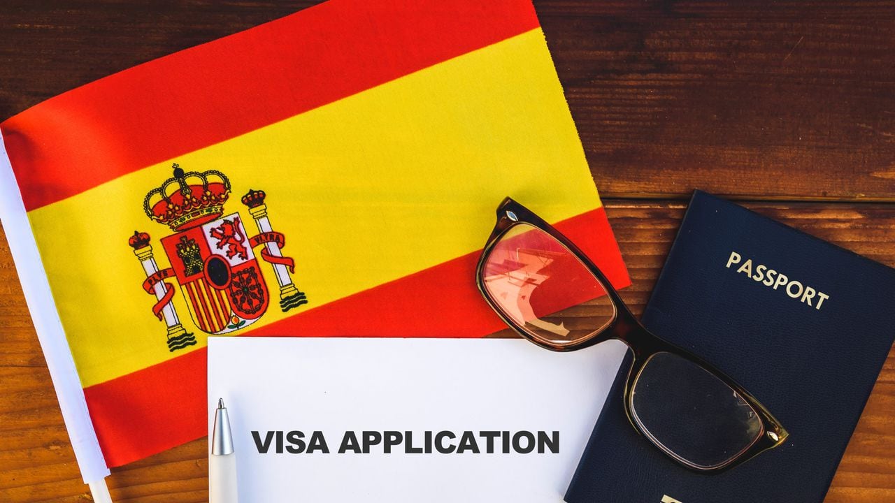 Flag of Spain , visa application form and passport on table