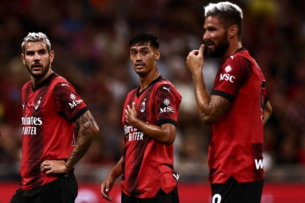AC Milan�s defender Theo Hernandez from France (L) and AC Milan�s midfielder Rade Krunic from Bosnia Herzegovina (C) look at AC Milan�s teammate Olivier Giroud from France during the Italian Serie A football match AC Milan vs Torino on August 26, 2023 at the �San Siro Stadium� in Milan. (Photo by MARCO BERTORELLO / AFP)