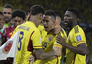 Colombia's Rafael Santos Borre, center, celebrates with teammates after scoring his side's opening goal against Venezuela during a qualifying soccer match for the FIFA World Cup 2026 at Metropolitano stadium in Barranquilla, Colombia, Thursday, Sept. 7, 2023. (AP Photo/Ricardo Mazalan)