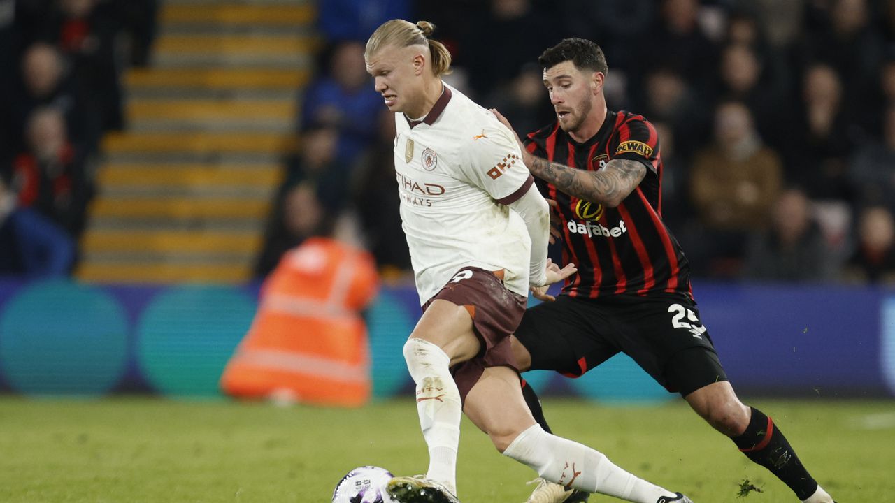 Bournemouth's Marcos Senesi, right, challenges Manchester City's Erling Haaland during the English Premier League soccer match between Bournemouth and Manchester City at the Vitality stadium in Bournemouth, England, Saturday, Feb. 24, 2024. (AP Photo/David Cliff)