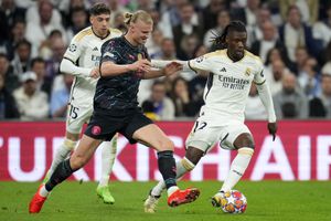 Manchester City's Erling Haaland fights for the ball with Real Madrid's Eduardo Camavinga during the Champions League quarterfinal first leg soccer match between Real Madrid and Manchester City at the Santiago Bernabeu stadium in Madrid, Spain, Tuesday, April 9, 2024. (AP Photo/Manu Fernandez)