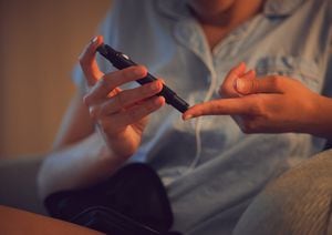 Diabetic, Diabetes or chronic disease by a woman testing blood sugar or glucose levels at home using a lancet pen. Closeup of a female piercing her finger to control her health condition