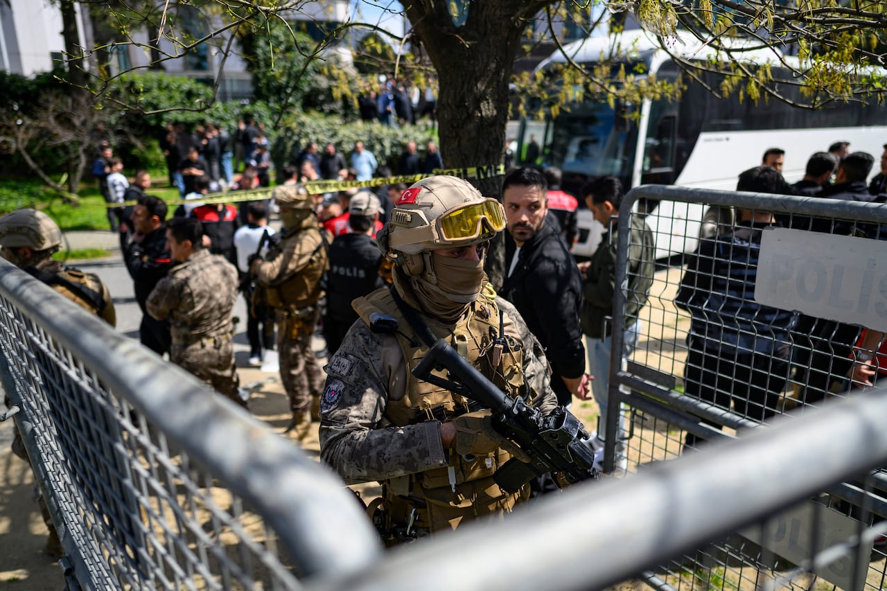 Police officials gather outside The Israeli Consulate in Istanbul on April 7, 2026, following a shootout between gunmen and police. One gunman was killed and two others were wounded in a shootout with police outside the Israeli consulate in Istanbul, the local governor said, adding two officers were lightly wounded (Photo by Yasin AKGUL / AFP)