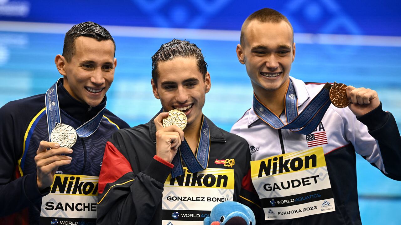 (De izquierda a derecha) Gustavo Sánchez, de Colombia, medallista de plata, Dennis González Boneu, de España, medallista de oro, y Kenneth Gaudet, de Estados Unidos, medallista de bronce, posan durante la ceremonia de entrega de medallas para el evento masculino de natación artística libre en solitario durante el Campeonato Mundial de Natación en Fukuoka el 19 de julio de 2023. (Foto de Philip FONG / AFP)