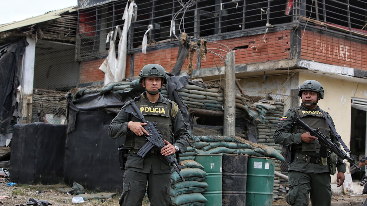 Police stand guard before a damaged police station after a car bomb exploded, in Timba, Cauca, Colombia, Sunday, Aug. 13, 2023. According to police, the car bomb killed one police officer. (AP Photo/Andres Quintero)