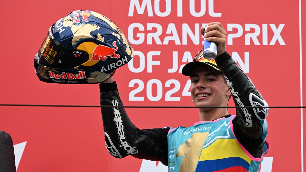 CFMOTO Aspar Team rider David Alonso of Colombia celebrates his victory and the 2024 World Champion on the podium after winning the Moto3 class race of the MotoGP Japanese Grand Prix at the Mobility Resort Motegi in Motegi, Tochigi prefecture on October 6, 2024. (Photo by Toshifumi KITAMURA / AFP)