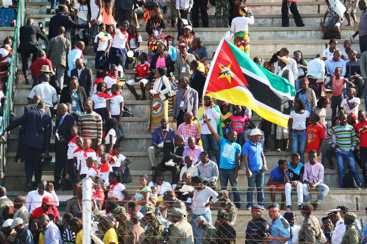 Mozambican people celebrate, some waving Mozambican national flags, during the celebrations for the 40th anniversary of Mozambican independence from Portugal at the Machava stadium on June 25, 2015 in Maputo.
AFP PHOTO/ADRIEN BARBIER (Photo by Adrien BARBIER / AFP)