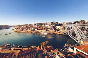 oporto city with douro river and dom luiz bridge under blue sky, portugal.
